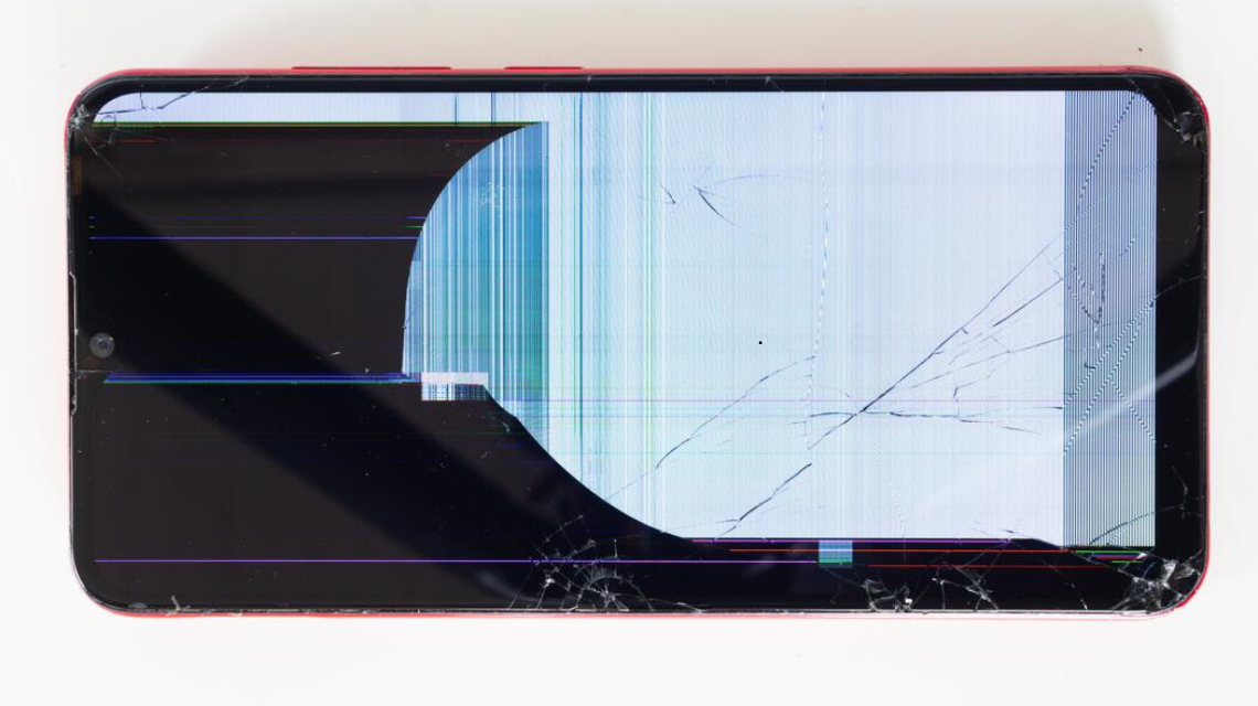 Close-up of cracked phone screen damage