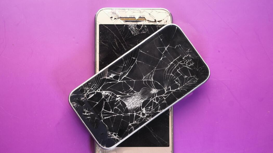 Severely cracked mobile display with black spots