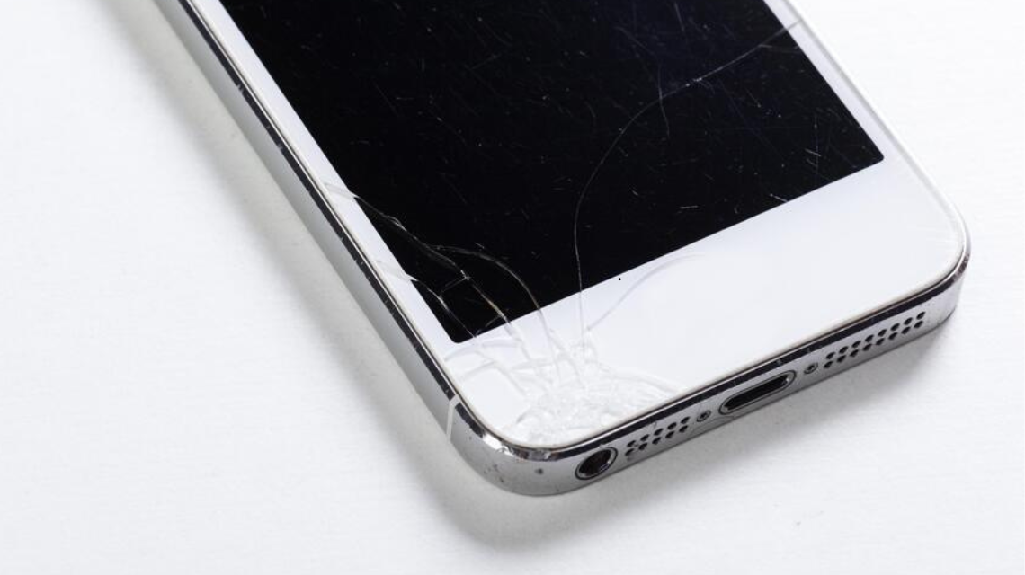 Shattered phone screen with visible scratches